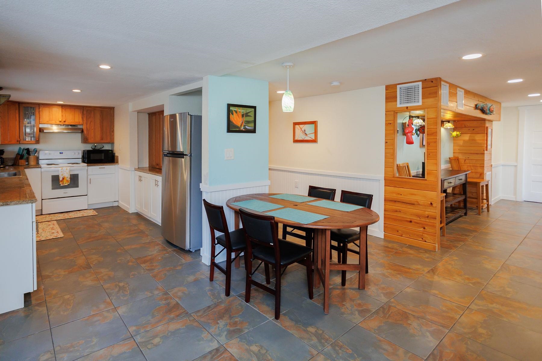 6194 Bear Trail Weeki Wachee, FL 34607 - Photo 16 of 68 a open kitchen with stainless steel appliances kitchen island granite countertop a table and chairs in it