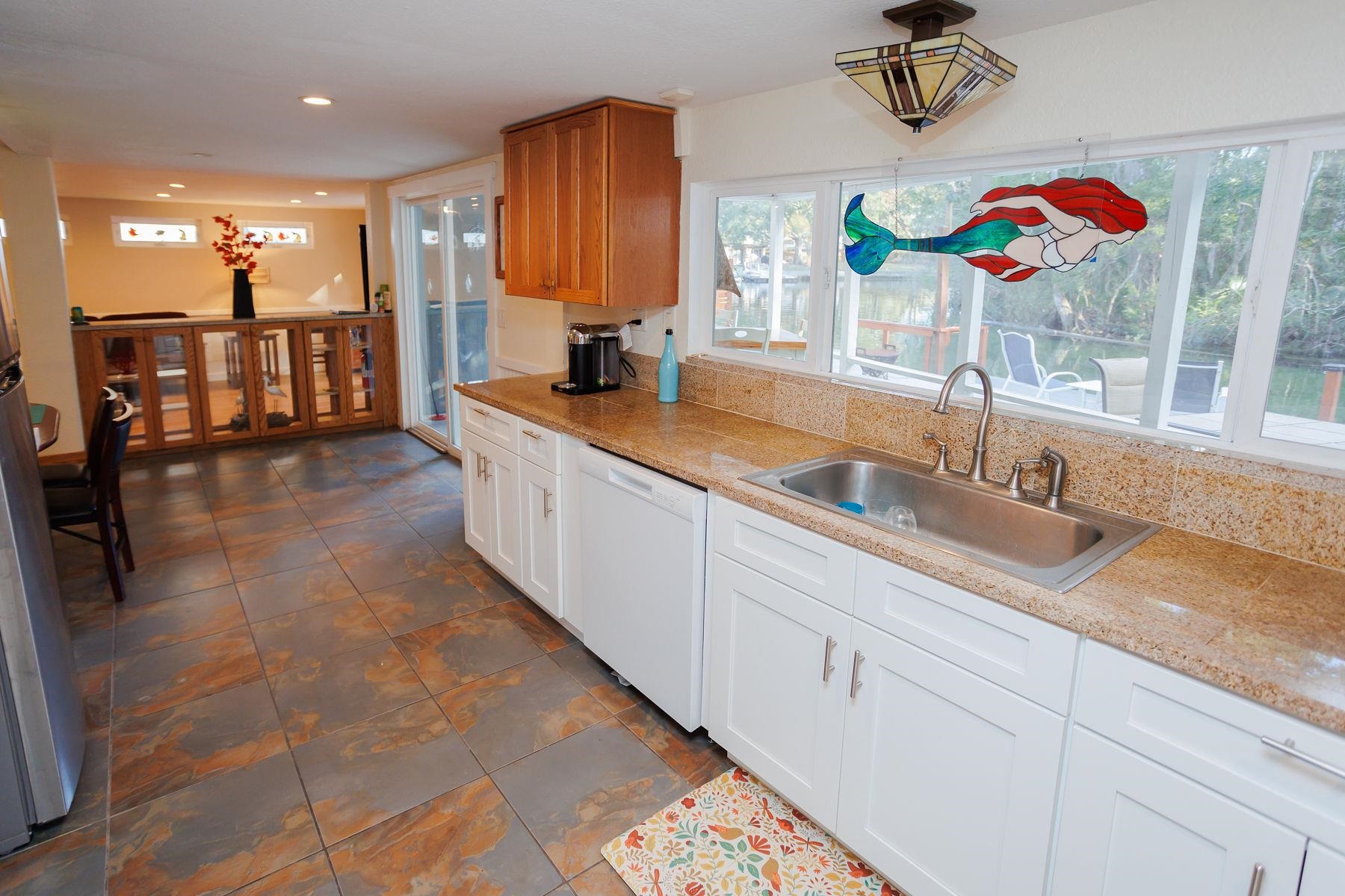 6194 Bear Trail Weeki Wachee, FL 34607 - Photo 20 of 68 a kitchen with stainless steel appliances granite countertop a sink and a counter space