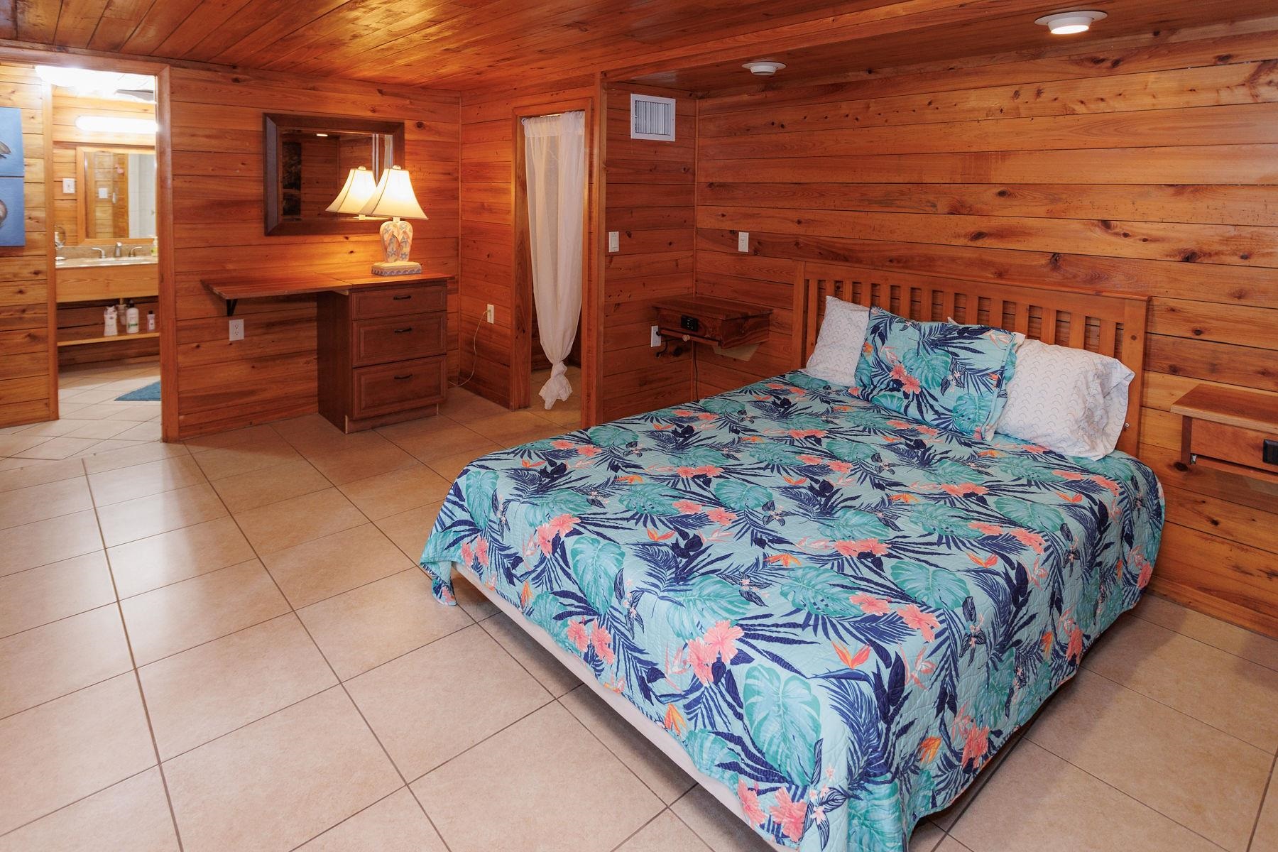 6194 Bear Trail Weeki Wachee, FL 34607 - Photo 23 of 68 a bedroom with a bed and wooden floor