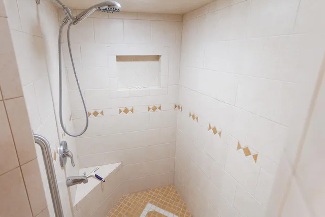a bathroom with a bathtub and a shower