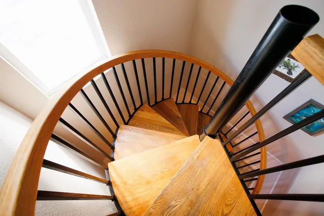 a dining room with furniture and a floor to ceiling window