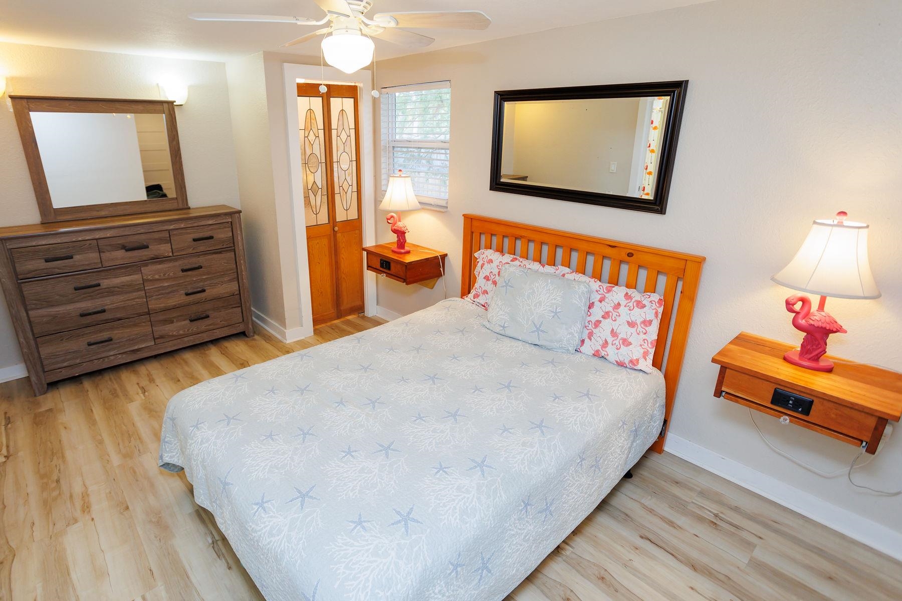 6194 Bear Trail Weeki Wachee, FL 34607 - Photo 32 of 68 a bedroom with a bed and wooden floor