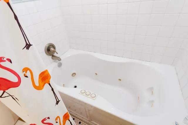 a front view of a house with a tree