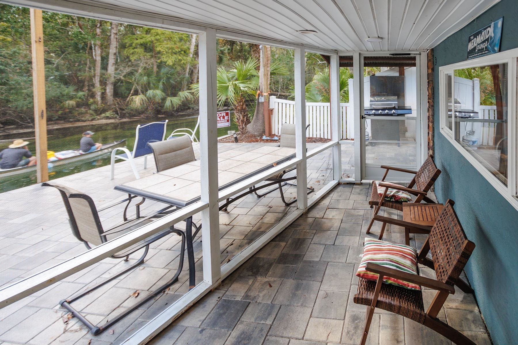 6194 Bear Trail Weeki Wachee, FL 34607 - Photo 36 of 68 a view of a living room and balcony with furniture and garden view