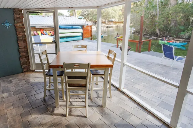 a view of a porch with furniture and a yard