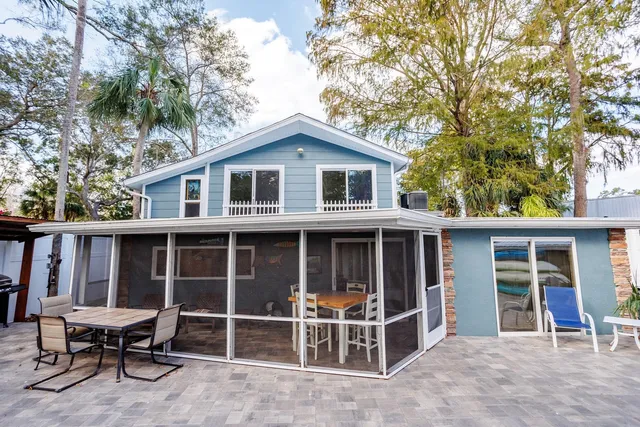 a bench sitting in the middle of a park with large trees