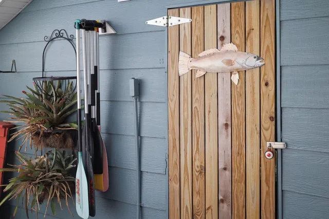 an aerial view of a house with a yard and lake view