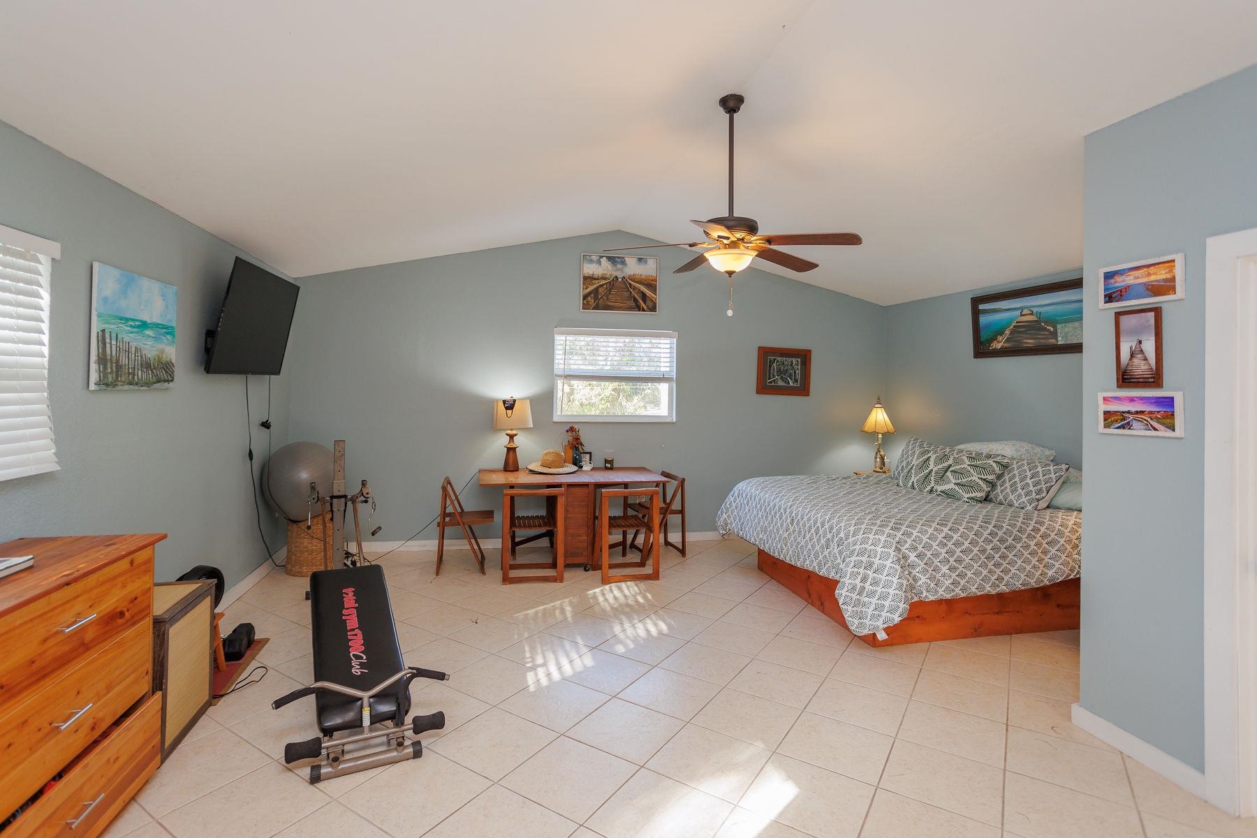 6194 Bear Trail Weeki Wachee, FL 34607 - Photo 54 of 68 a bedroom with furniture and a gym equipment