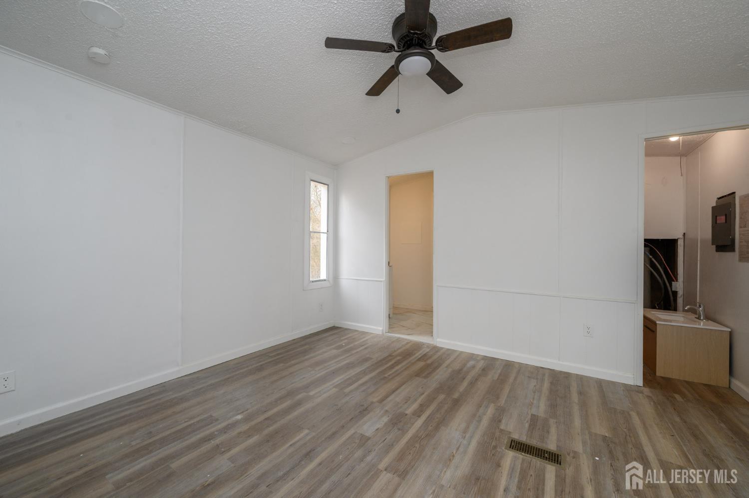 448 Evergreen Road Millville, NJ 08332 - Photo 15 of 29 a view of empty room with wooden floor and fan