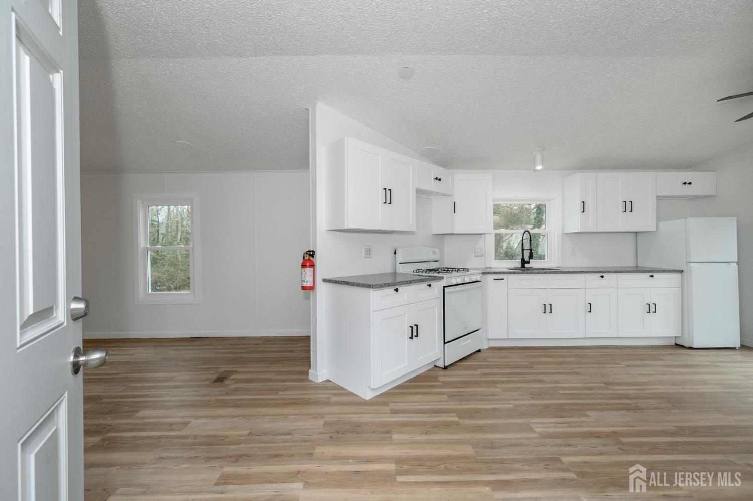 448 Evergreen Road Millville, NJ 08332 - Photo 2 of 29 a kitchen with white cabinets sink and window
