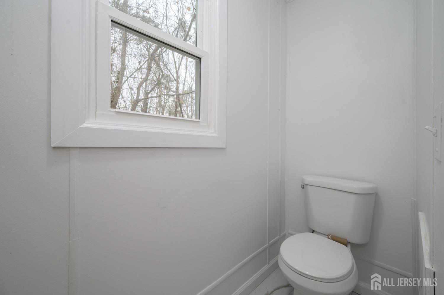 448 Evergreen Road Millville, NJ 08332 - Photo 21 of 29 a white toilet sitting next to a window in a bathroom