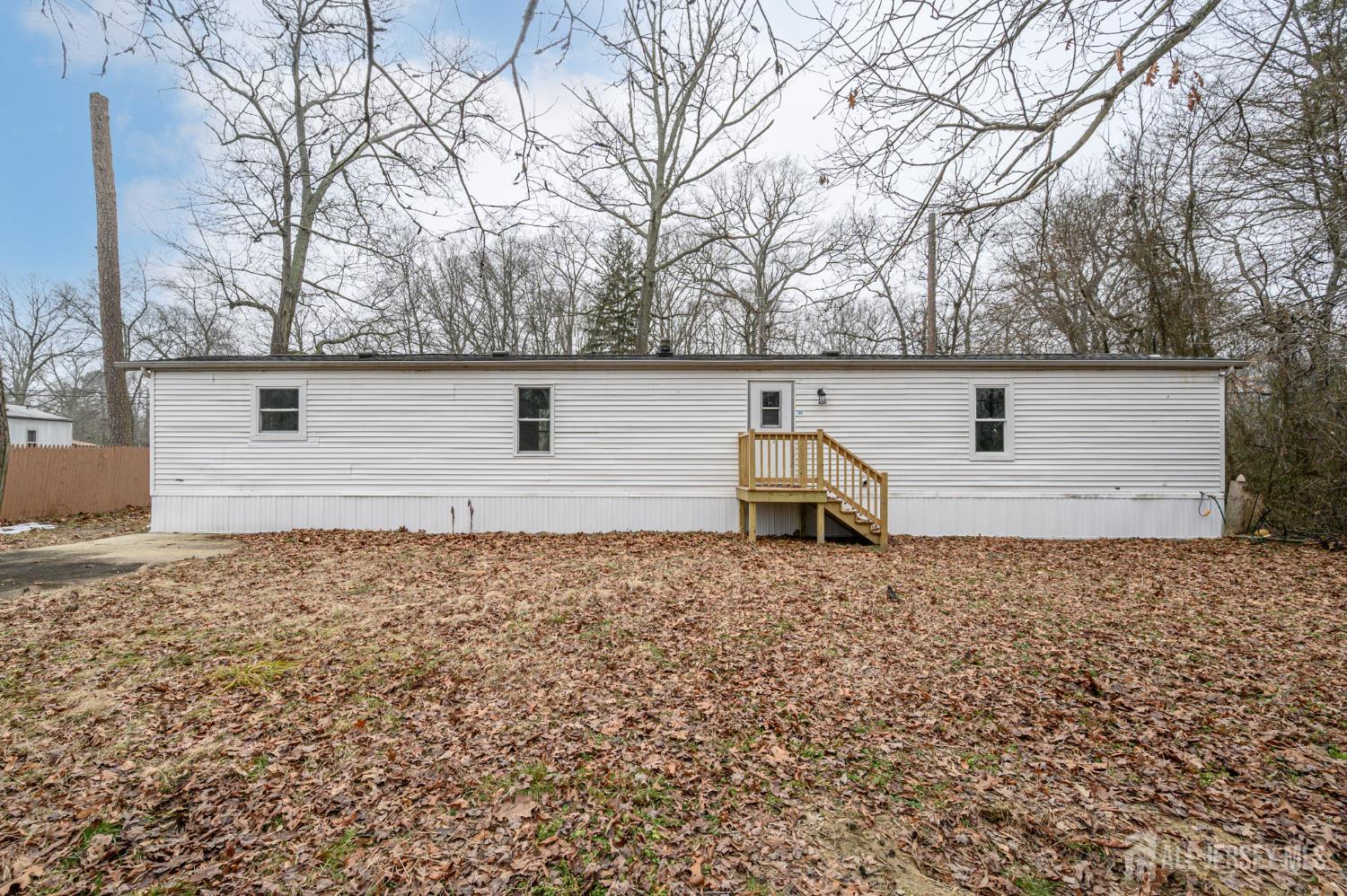 448 Evergreen Road Millville, NJ 08332 - Photo 24 of 29 a backyard of a house with large trees and brick walls