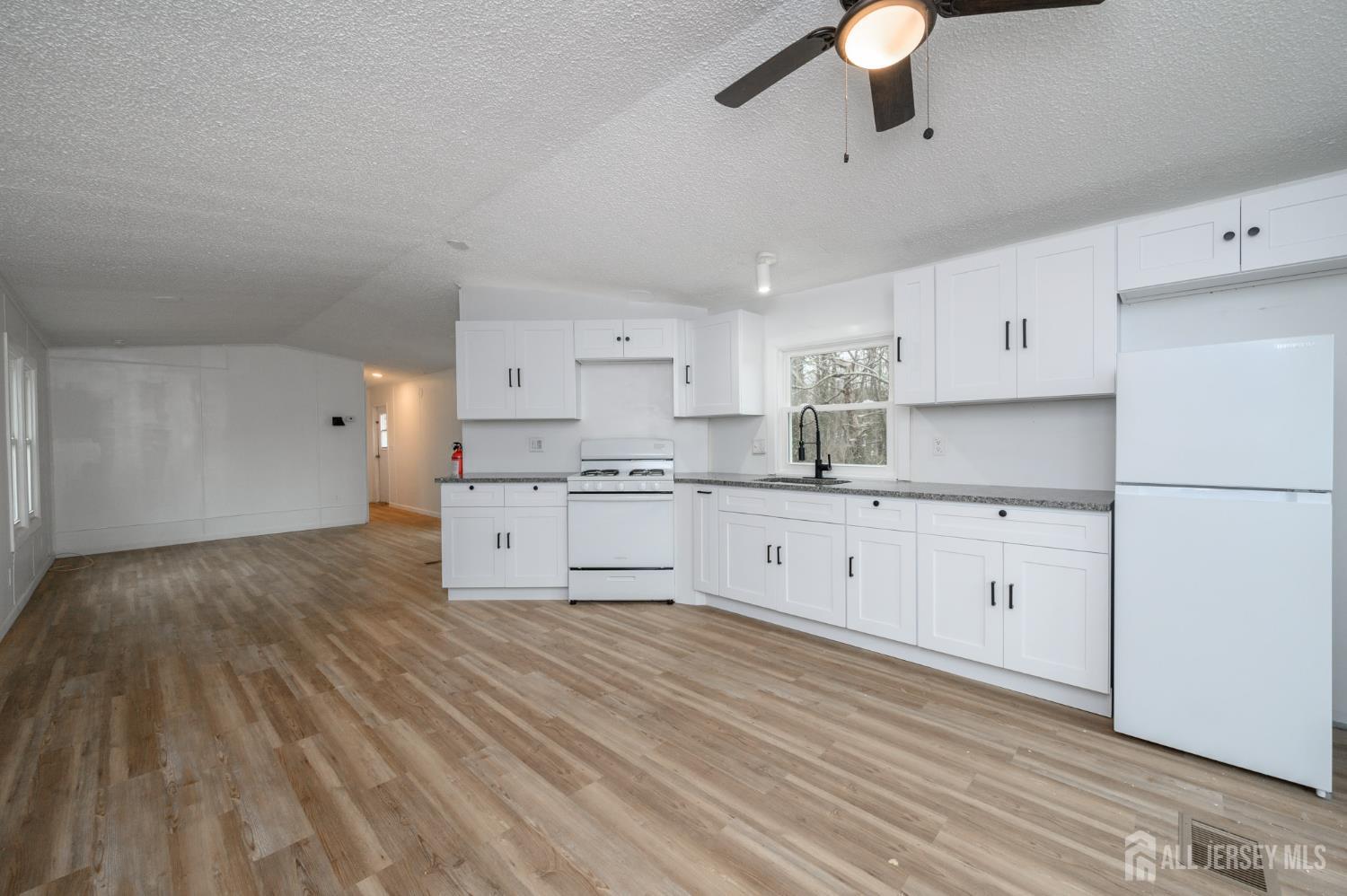 448 Evergreen Road Millville, NJ 08332 - Photo 4 of 29 a kitchen with cabinets oven a sink and dishwasher with wooden floor