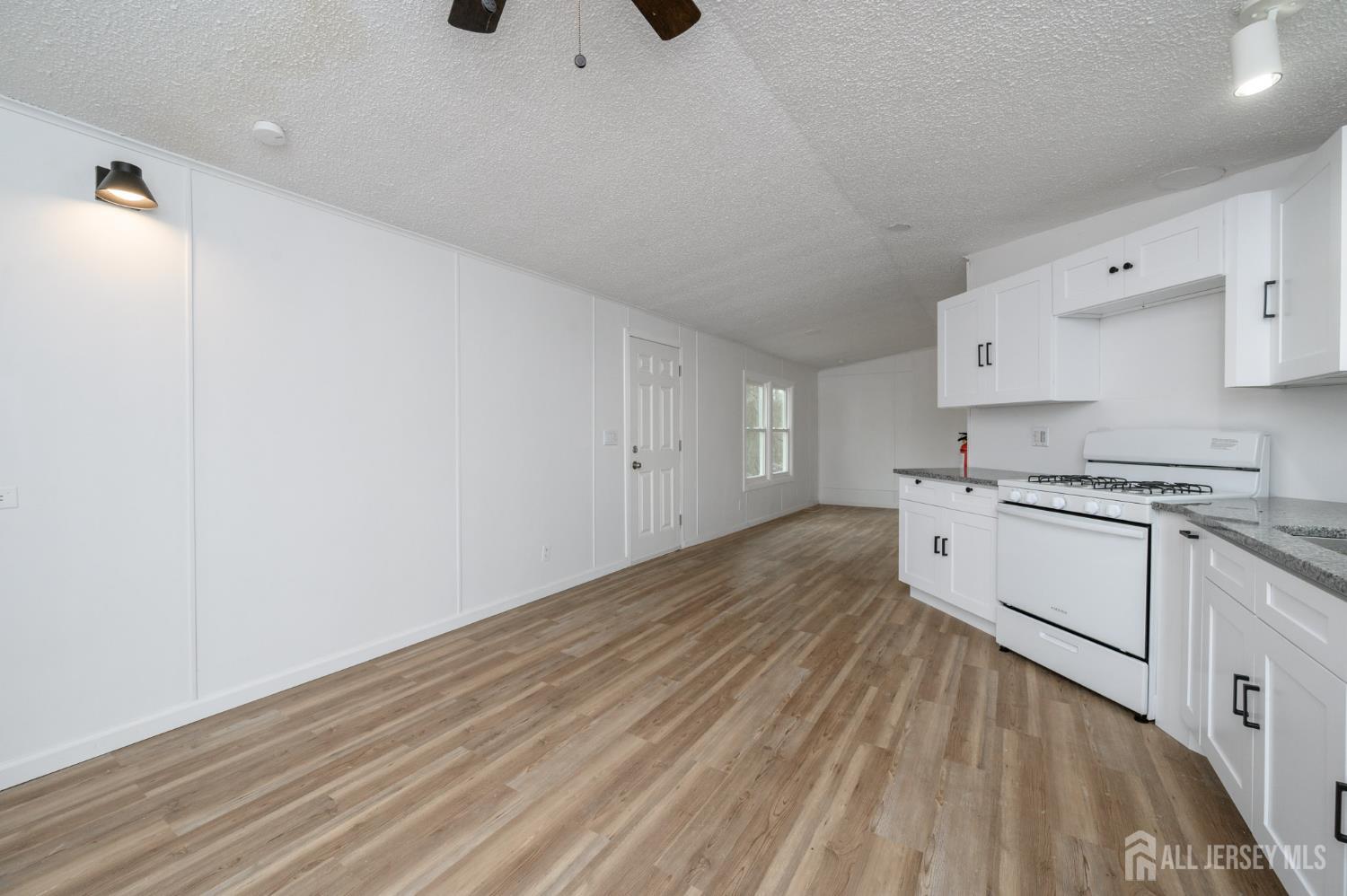 448 Evergreen Road Millville, NJ 08332 - Photo 5 of 29 a kitchen with granite countertop white cabinets and white appliances