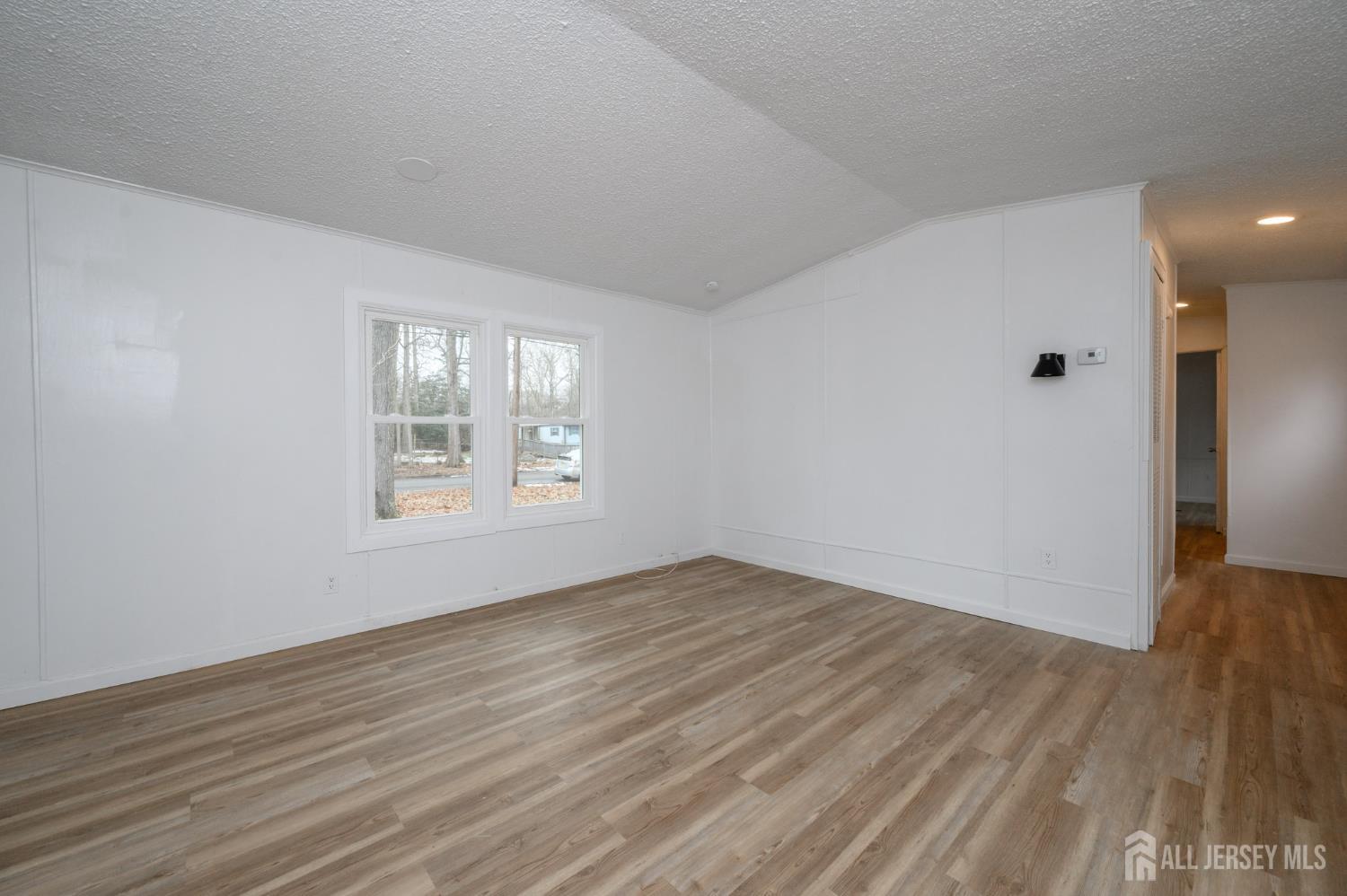 448 Evergreen Road Millville, NJ 08332 - Photo 9 of 29 a view of an empty room with wooden floor and a window