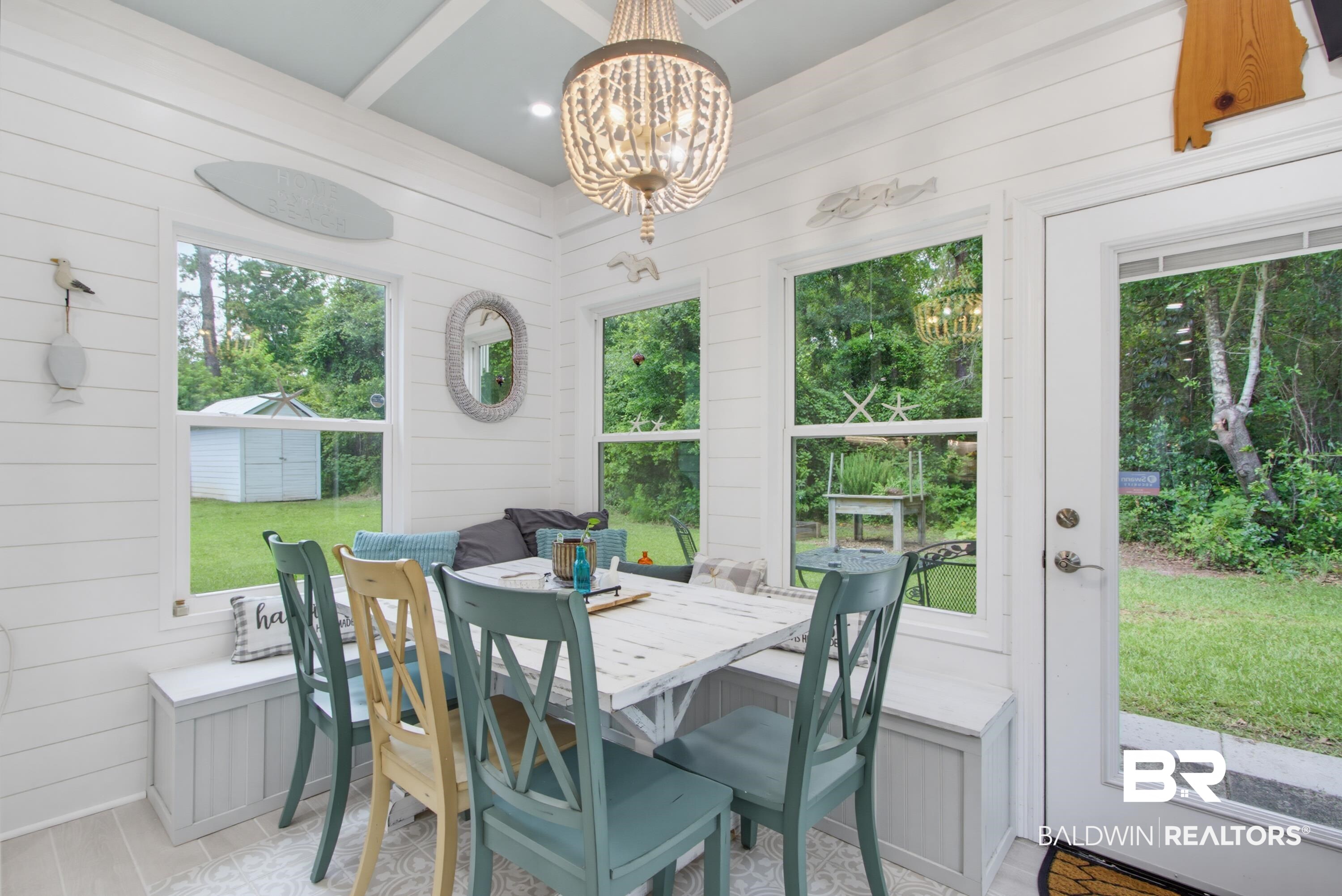 7472 Coopers Landing Road Foley, AL 36535 - Photo 13 of 40 Dining area featuring white shiplap walls, multiple windows, and a bead chandelier