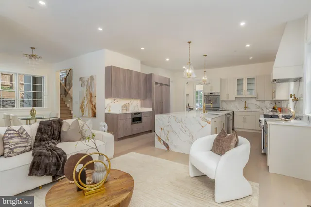 a large kitchen with kitchen island a sink dining table and chairs
