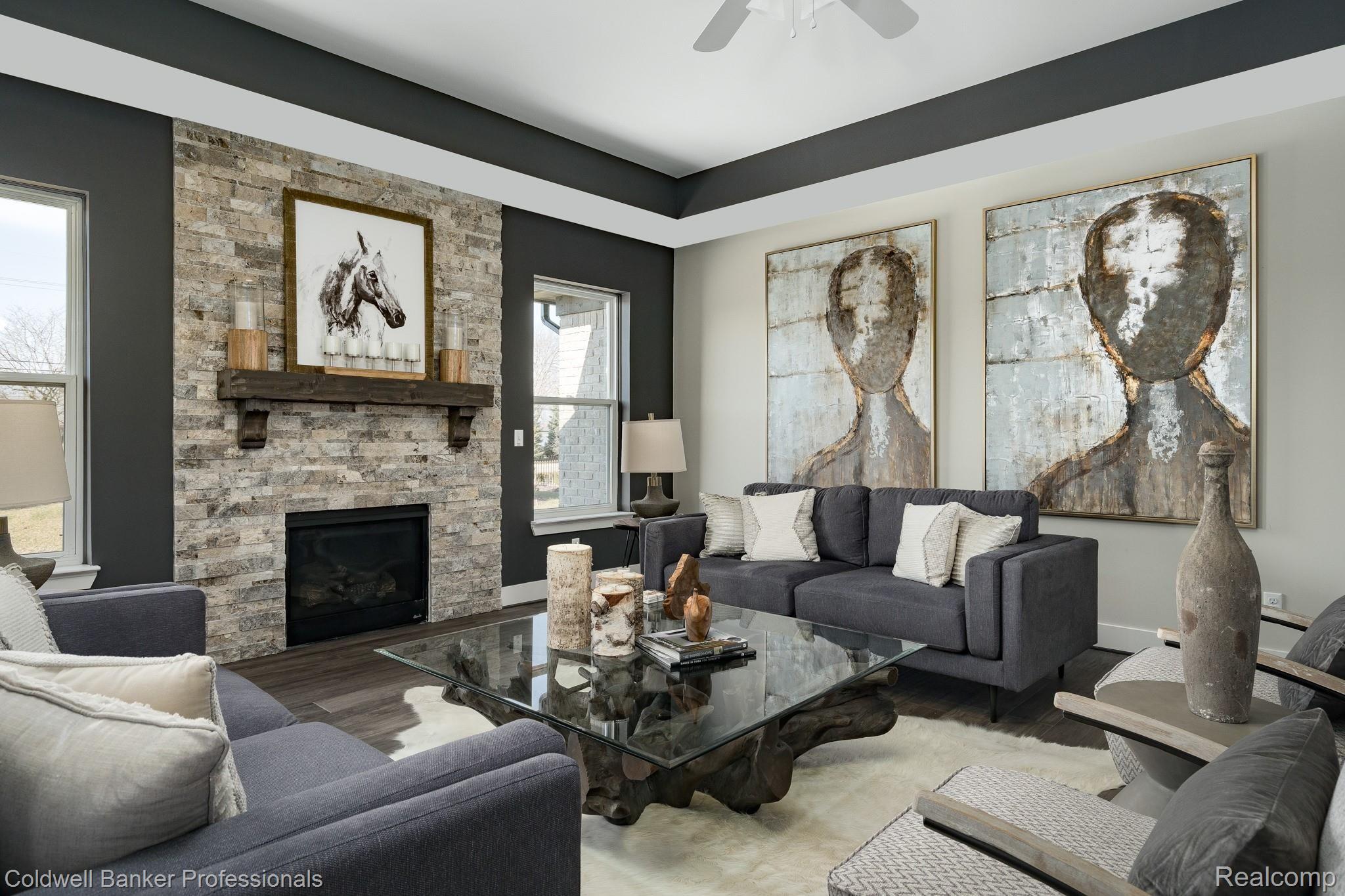 Stone gas fireplace with custom mantle and step up ceilings