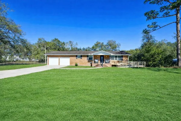 a front view of a house with a garden