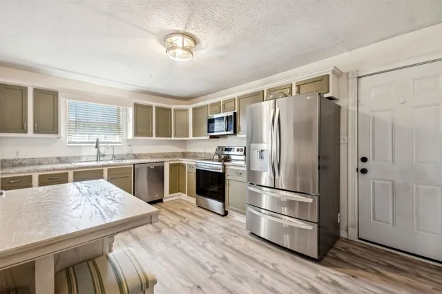 a bedroom with bed and a flat screen tv