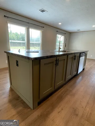 a kitchen with granite countertop a stove and a sink