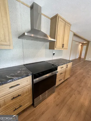 a view of a room with wooden floor and chair