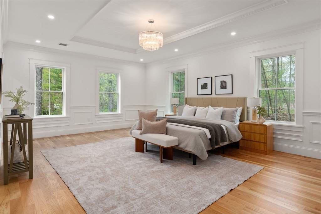 82 Deer Path Lane Weston, MA 02493 - Photo 23 of 42 a spacious bedroom with a large bed and a couch