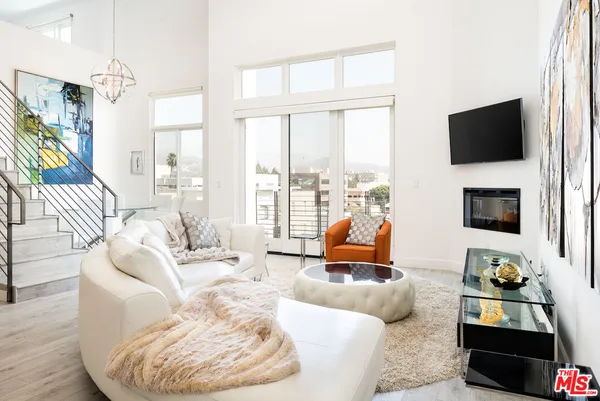 a living room with furniture fireplace and a flat screen tv