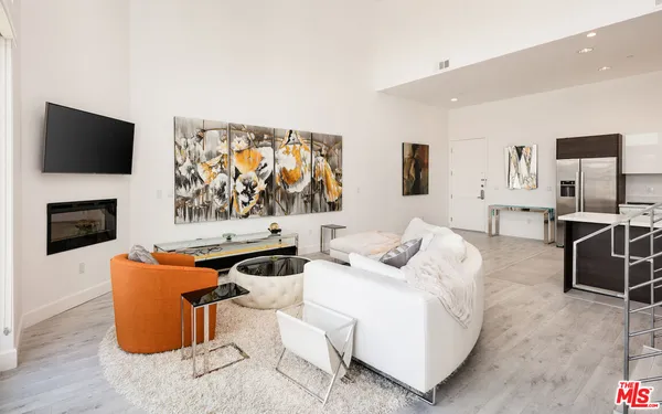 a living room with furniture fireplace and flat screen tv