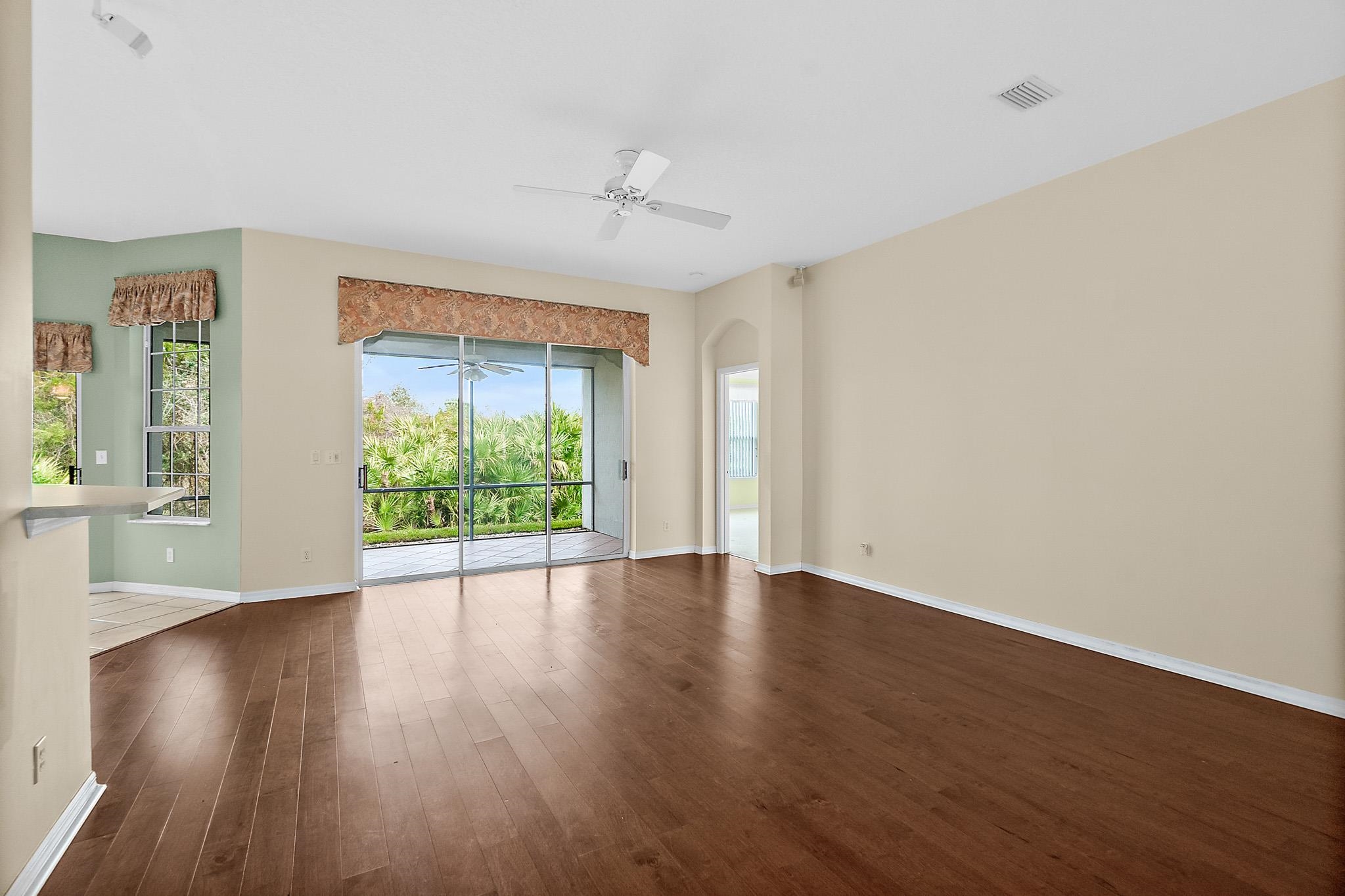 644 Casa Fuerta Lane St. Augustine, FL 32080 - Photo 12 of 49 an empty room with wooden floor and windows