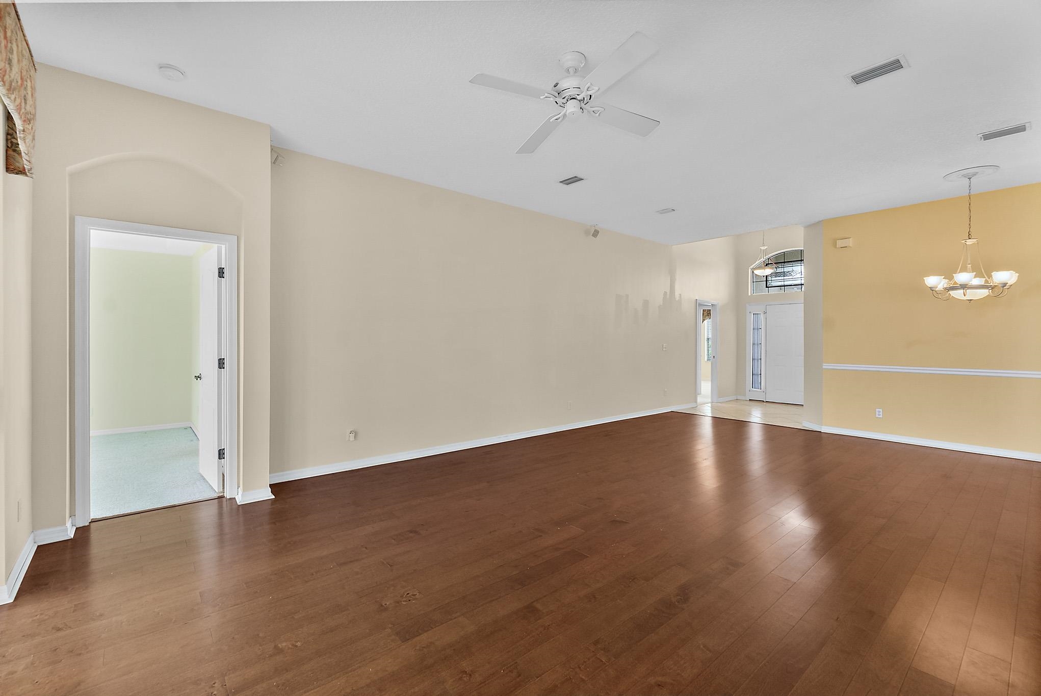 644 Casa Fuerta Lane St. Augustine, FL 32080 - Photo 13 of 49 an empty room with wooden floor and windows