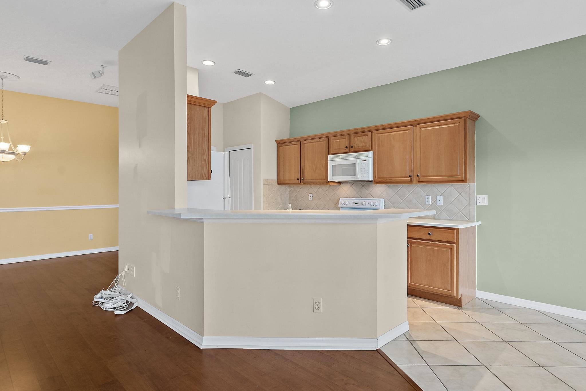 644 Casa Fuerta Lane St. Augustine, FL 32080 - Photo 14 of 49 a kitchen with stainless steel appliances granite countertop a refrigerator and a stove top oven