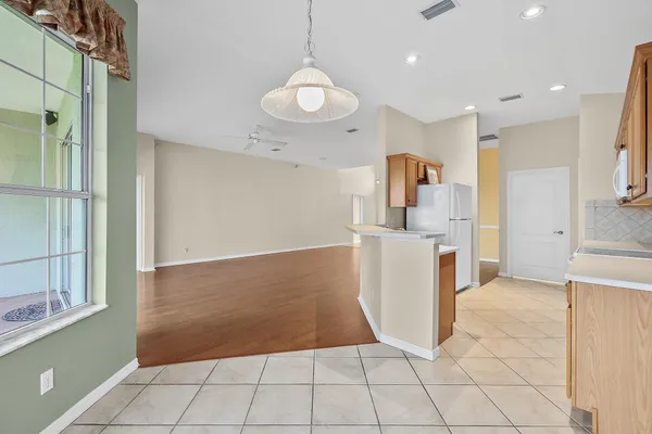 a view of a kitchen with wooden floor and a sink