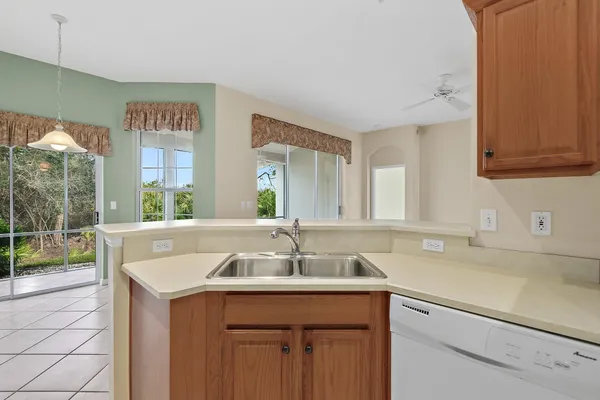 a kitchen with a sink and large window