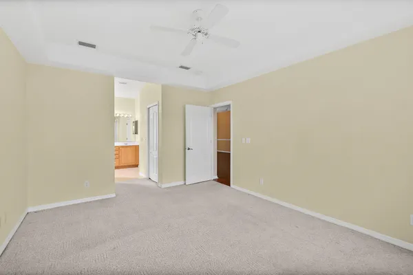 a view of an empty room and a ceiling fan