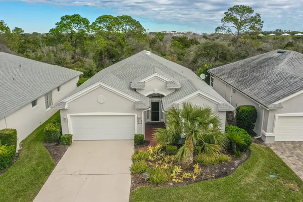 a aerial view of a house with a yard and potted plants