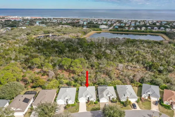 an aerial view of a house with a yard and lake view