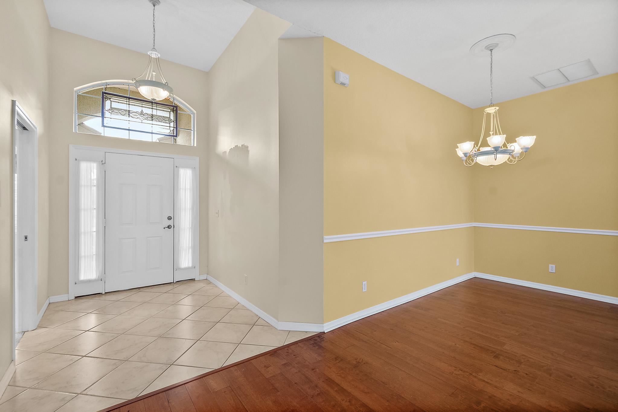 644 Casa Fuerta Lane St. Augustine, FL 32080 - Photo 5 of 49 an empty room with chandelier fan and kitchen view