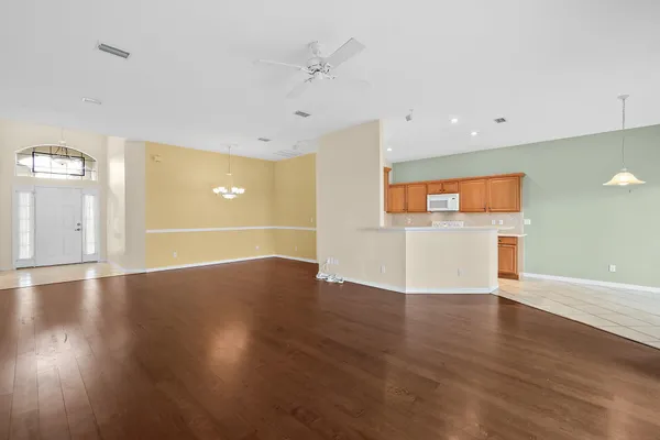 a view of a kitchen with a dishwasher and wooden floor