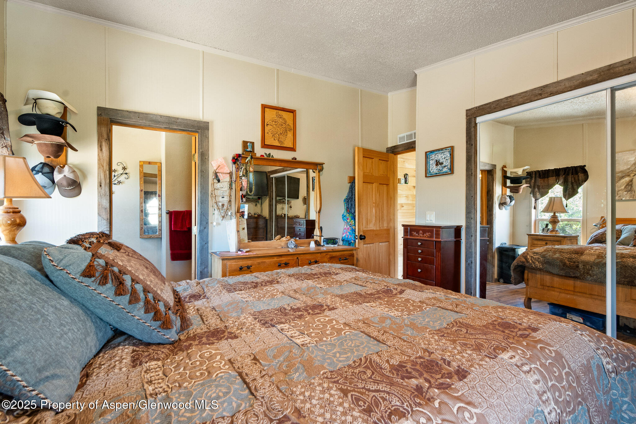 3768 County Road 237 Rifle, CO 81650 - Photo 19 of 47 a bedroom with bed and glass door
