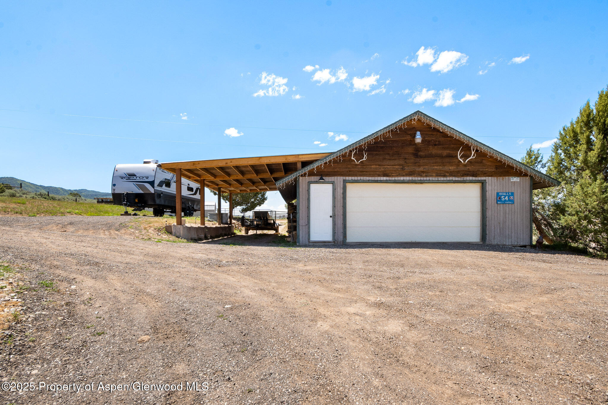 3768 County Road 237 Rifle, CO 81650 - Photo 29 of 47 a front view of a house with a yard and garage