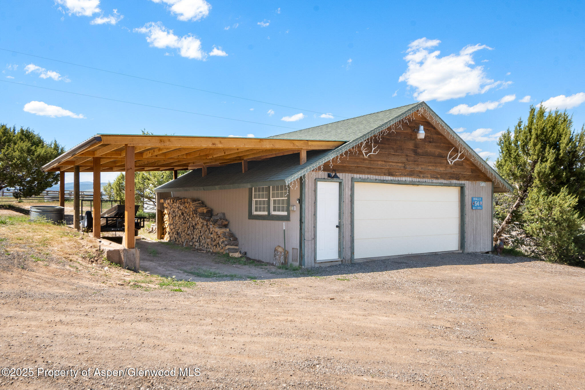3768 County Road 237 Rifle, CO 81650 - Photo 30 of 47 a front view of a house with a yard and garage