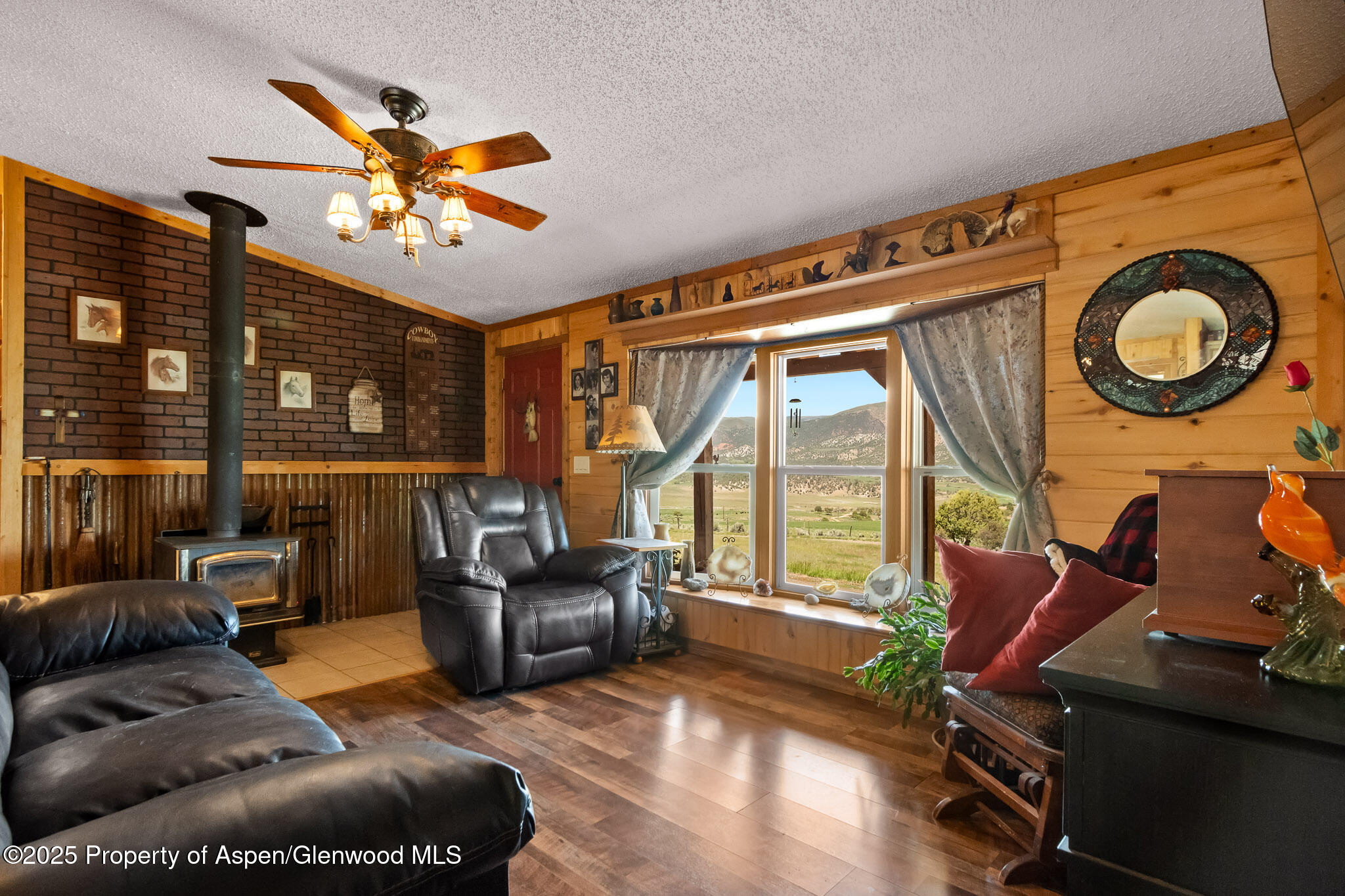 3768 County Road 237 Rifle, CO 81650 - Photo 8 of 47 a living room with furniture and a floor to ceiling window
