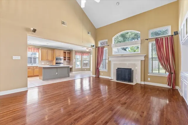 a view of an empty room with a fireplace and a window