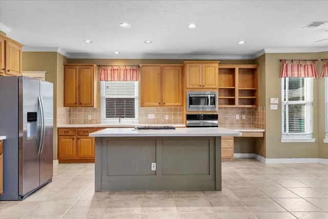 a kitchen with a sink window and refrigerator
