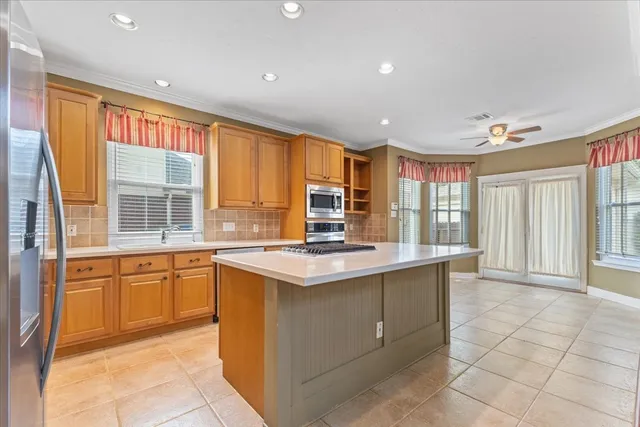 a kitchen with stainless steel appliances granite countertop a stove and a sink