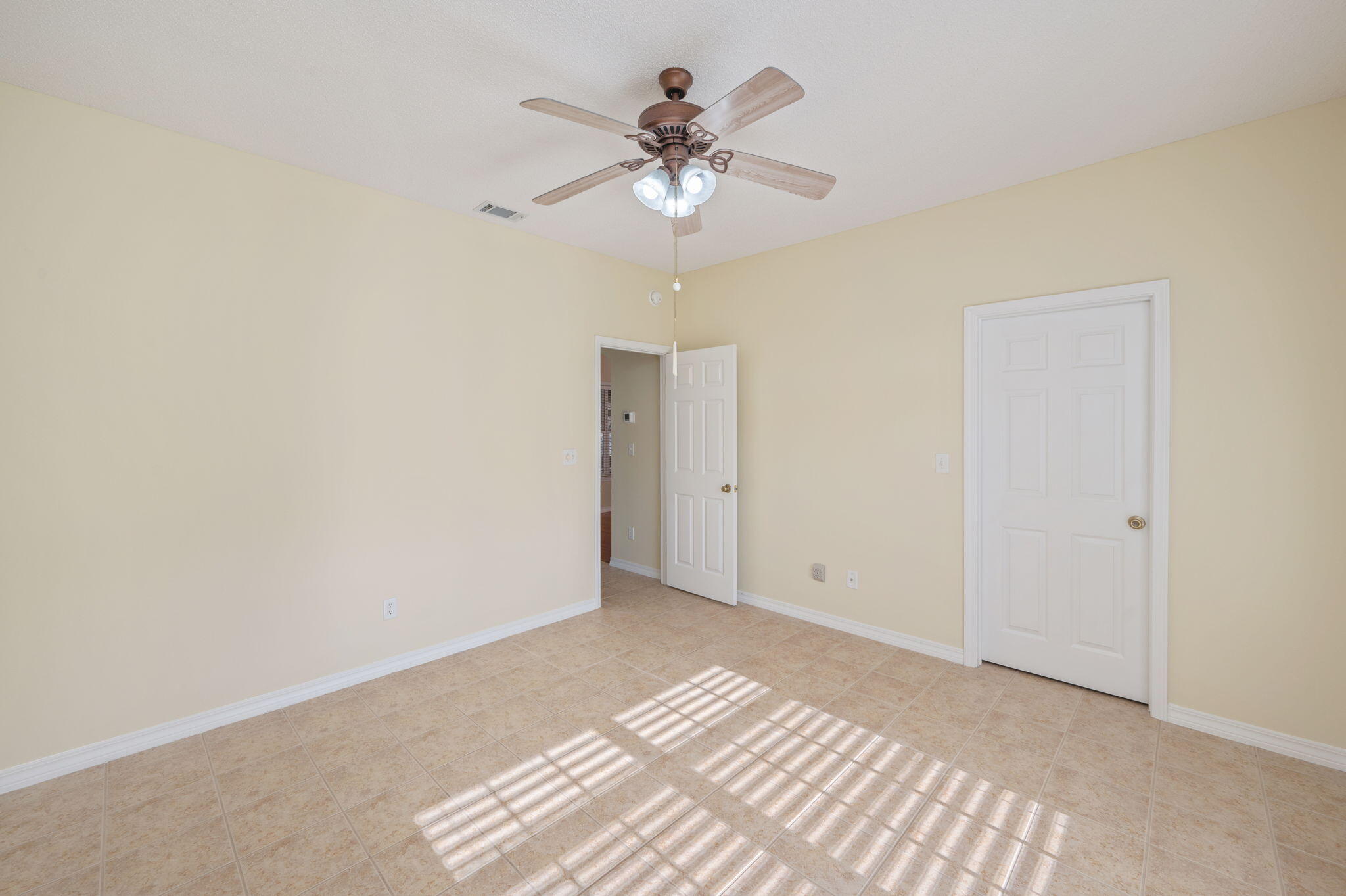 5552 Frontier Drive Crestview, FL 32536 - Photo 31 of 50 a view of an empty room with a ceiling fan