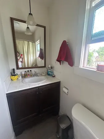 a bathroom with a toilet sink and mirror