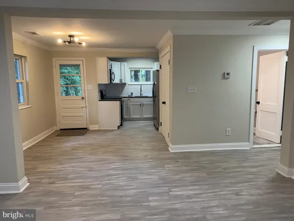 a view of kitchen with sink and refrigerator