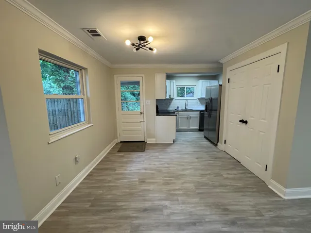 a kitchen with granite countertop a refrigerator and a sink